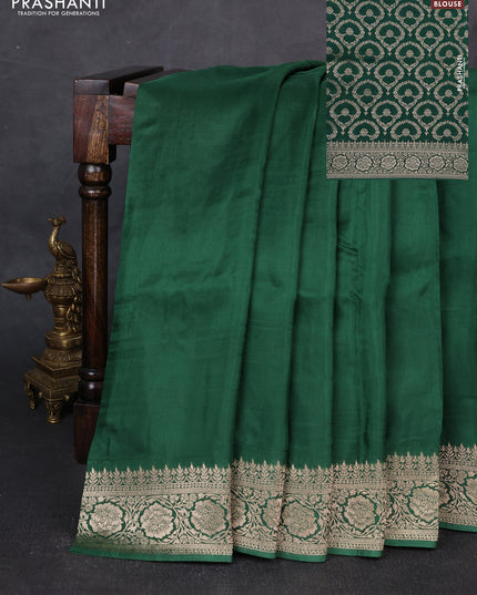 Dola silk saree bottle green with plain body and zari woven border
