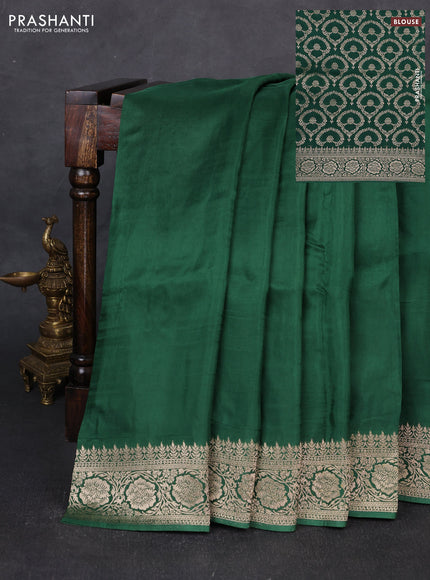 Dola silk saree bottle green with plain body and zari woven border
