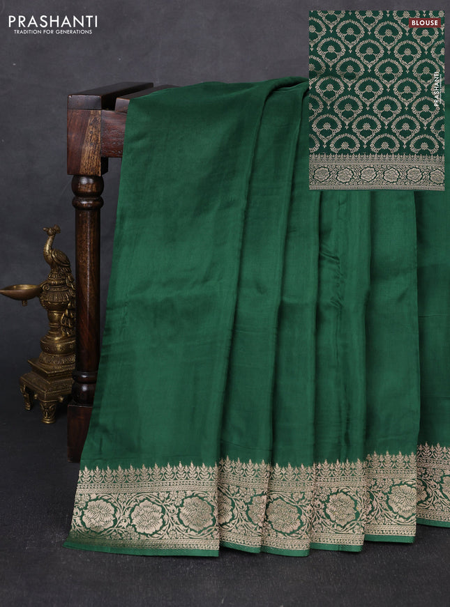 Dola silk saree bottle green with plain body and zari woven border