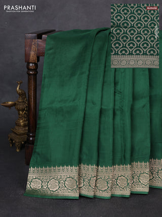 Dola silk saree bottle green with plain body and zari woven border