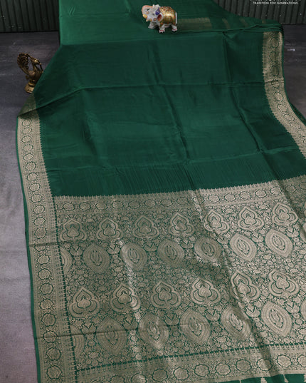 Dola silk saree bottle green with plain body and zari woven border