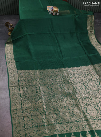 Dola silk saree bottle green with plain body and zari woven border