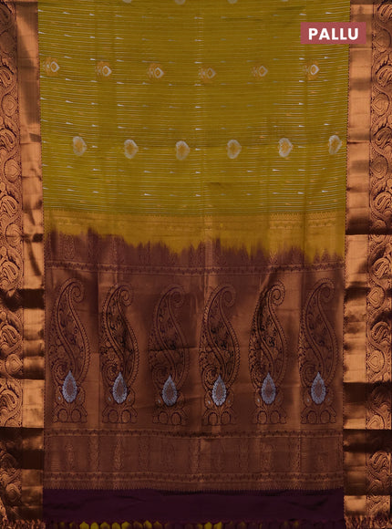 Semi soft silk saree mustard green and wine shade with allover silver & gold zari weaves & buttas and zari woven border