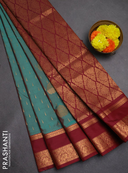 Semi soft silk saree teal green and maroon with allover zari woven buttas and rettapet zari woven border