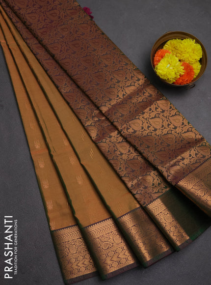 Semi soft silk saree dual shade of mustard green and bottle green with allover zari woven buttas and zari woven border