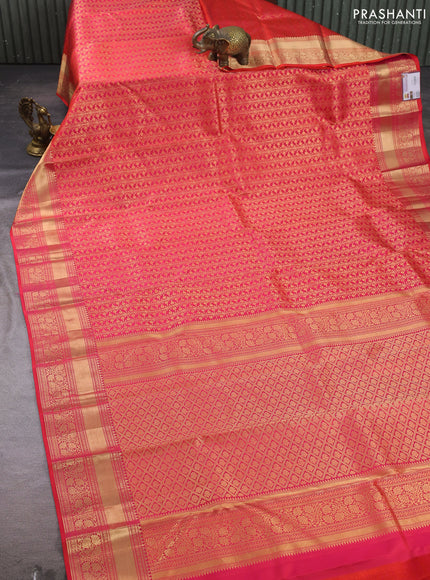 Pure kanchipuram silk saree dual shade of pinkish orange with allover zari woven brocade weaves and rich zari woven border