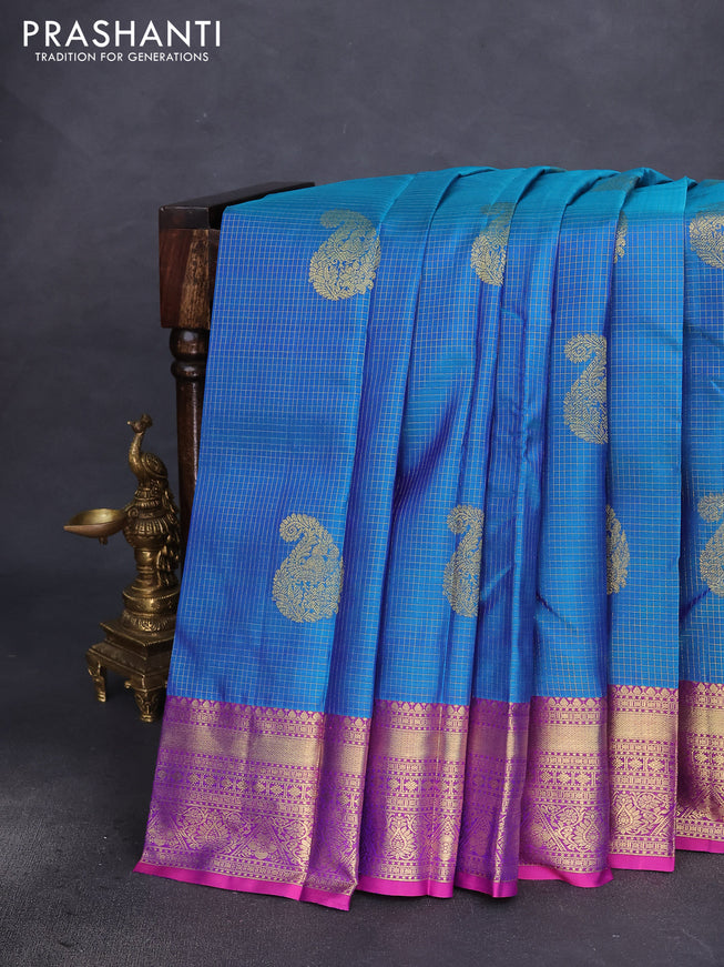 Pure kanchipuram silk saree dual shade of teal blue and dual shade of purple with allover zari checks & zari paisley buttas and zari woven border