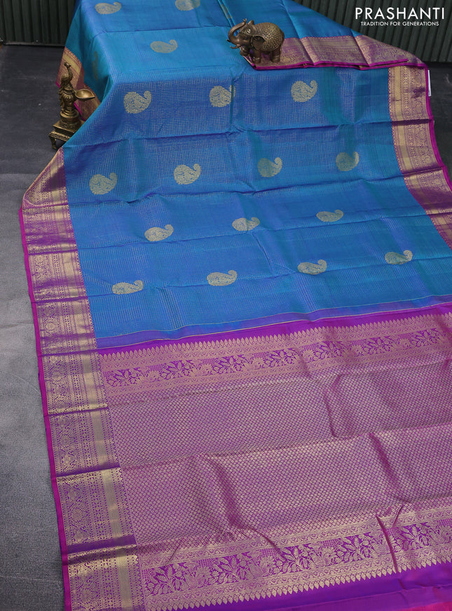 Pure kanchipuram silk saree dual shade of teal blue and dual shade of purple with allover zari checks & zari paisley buttas and zari woven border