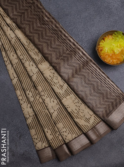 Semi chanderi saree sandal and pastel brown with allover floral prints and zari woven border