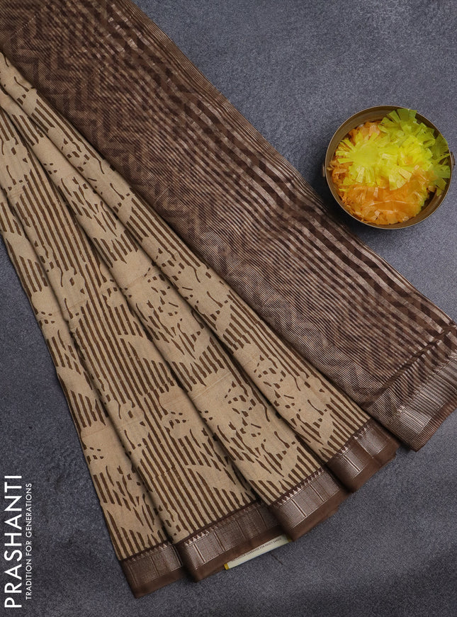 Semi chanderi saree sandal and pastel brown with allover floral prints and zari woven border