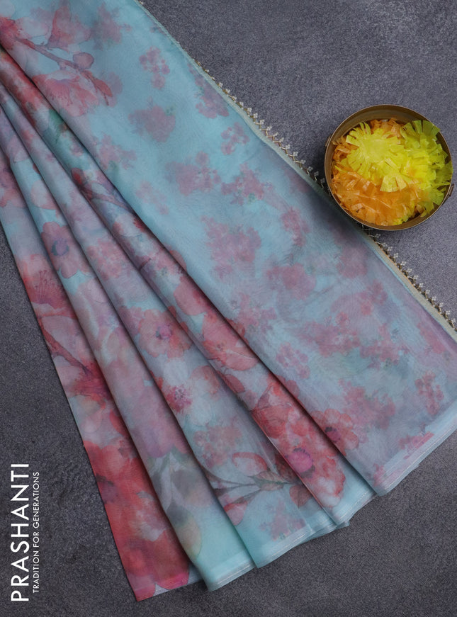 Semi organza saree teal blue with allover floral prints in borderless style