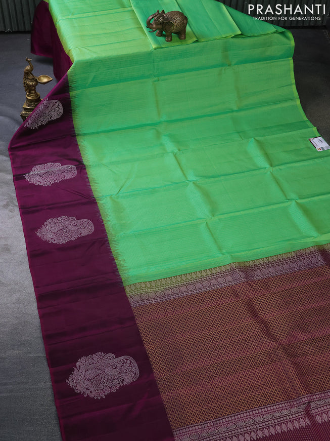 Pure soft silk saree dual shade of green and purple with allover small zari checked pattern and long silver zari woven butta border