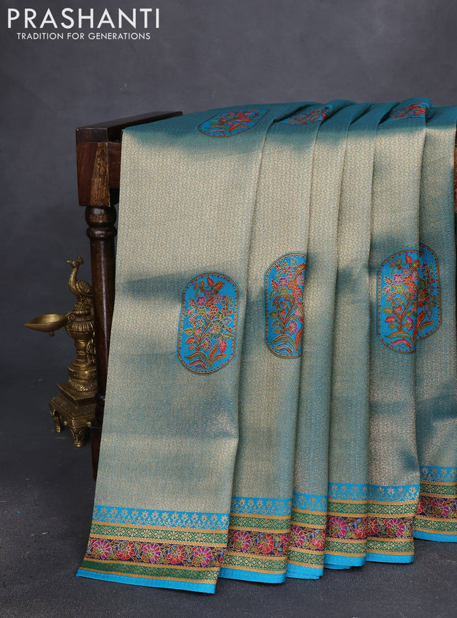 Banarasi silk saree teal blue shade with position prints and printed border