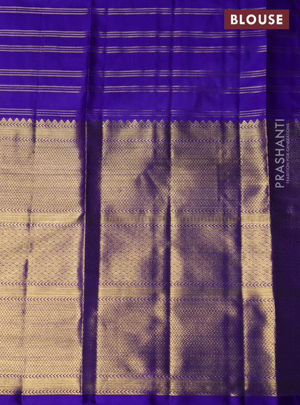 Pure kanchipuram silk lehenga dual shade of pinkish orange and blue with allover zari checks & buttas and long zari woven border