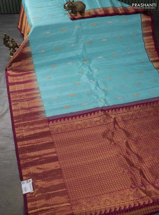 Pure gadwal silk saree light blue and wine shade with allover zari checks & buttas and long zari woven border