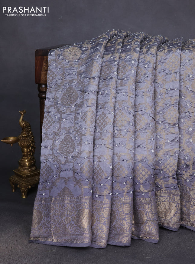 Chiniya silk saree grey with allover bandhani prints & zari weaves and zari woven border