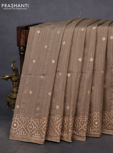 Semi tussar saree chikku shade and sandal with embroidery work buttas and embroidery mirror work border