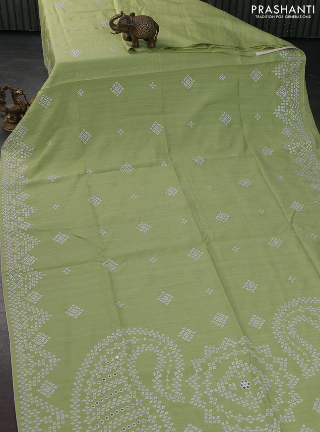 Semi tussar saree pista green and cream with embroidery work buttas and embroidery mirror work border