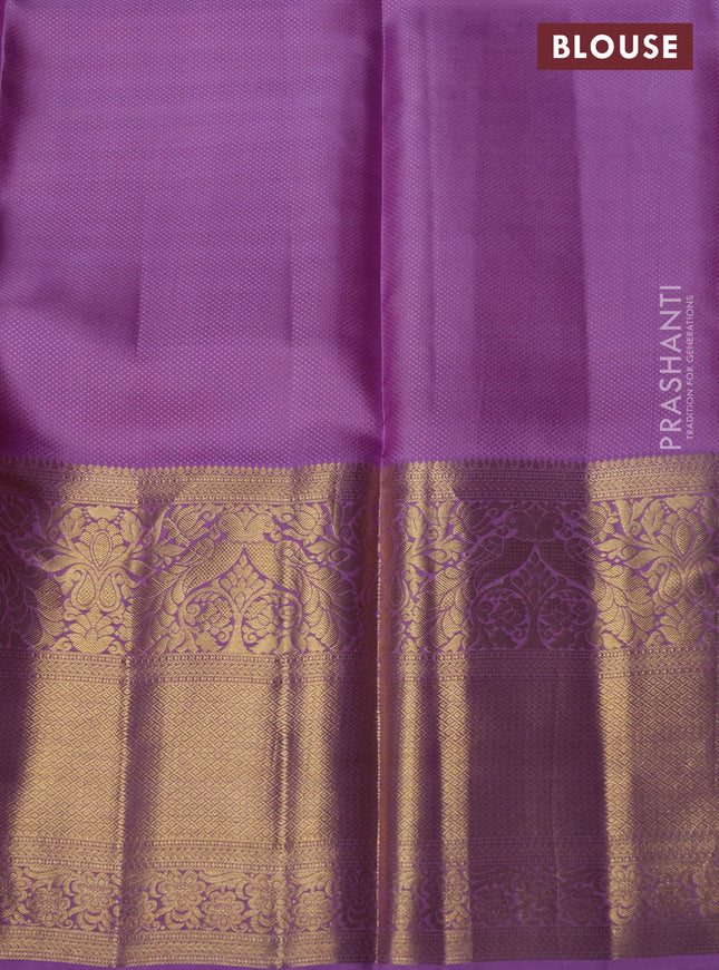 Pure kanchipuram silk lehenga orange and lavender with allover zari woven brocade weaves and long rich zari woven peacock border