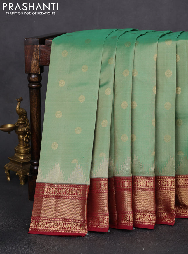 Pure kanchipuram silk saree pastel green shade and maroon with allover zari woven buttas and temple design zari woven border