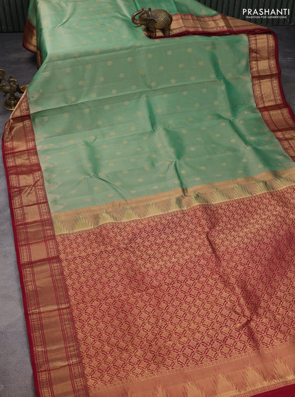 Pure kanchipuram silk saree pastel green shade and maroon with allover zari woven buttas and temple design zari woven border