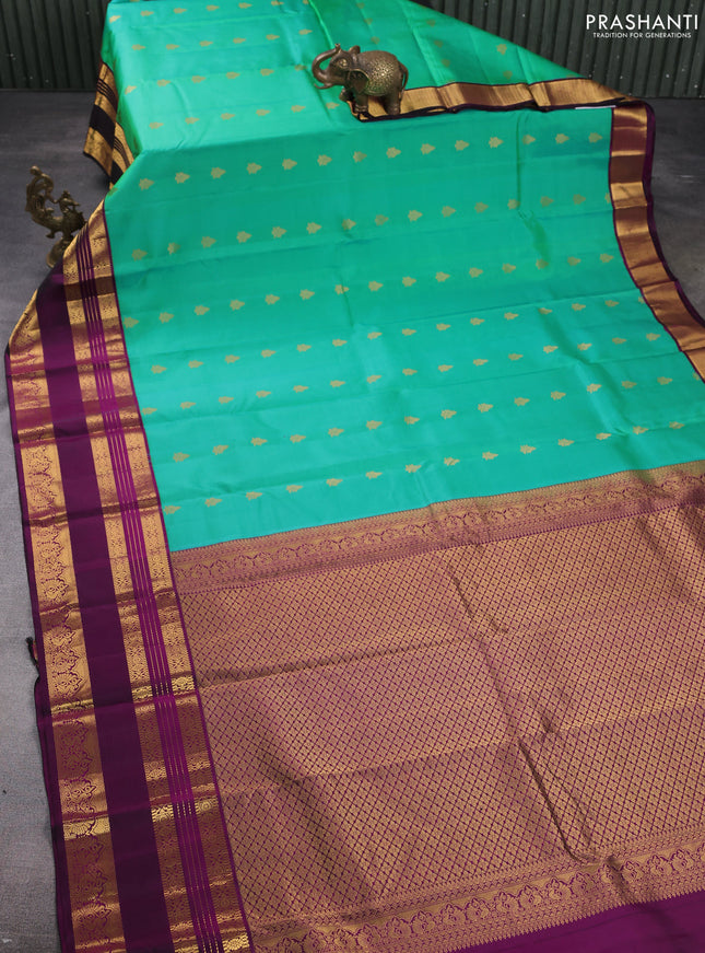 Pure kanchipuram silk saree dual shade of teal green and purple with zari woven buttas and rettapet zari woven korvai border