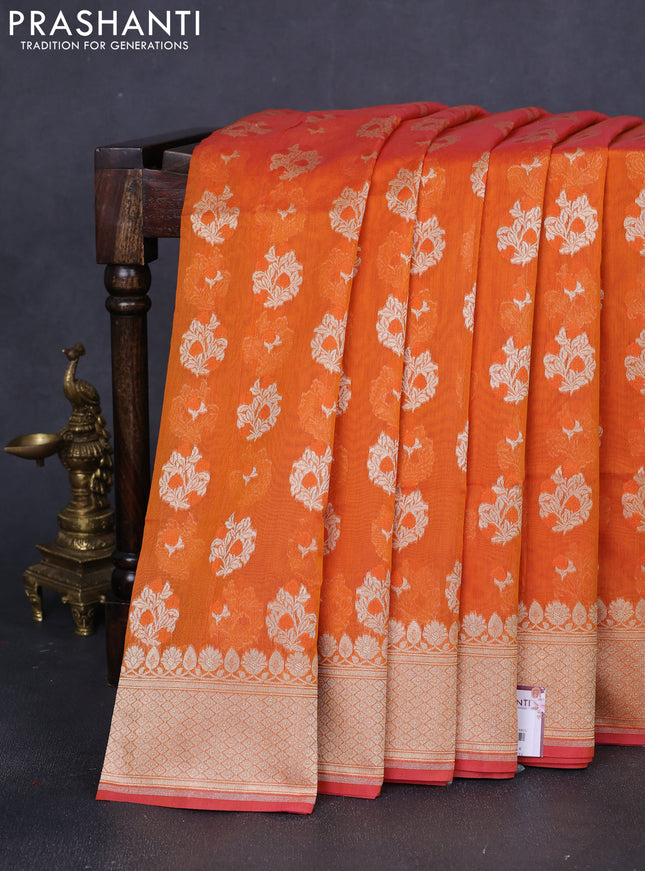 Banarasi silk cotton saree orange with allover floral zari woven buttas and zari woven border