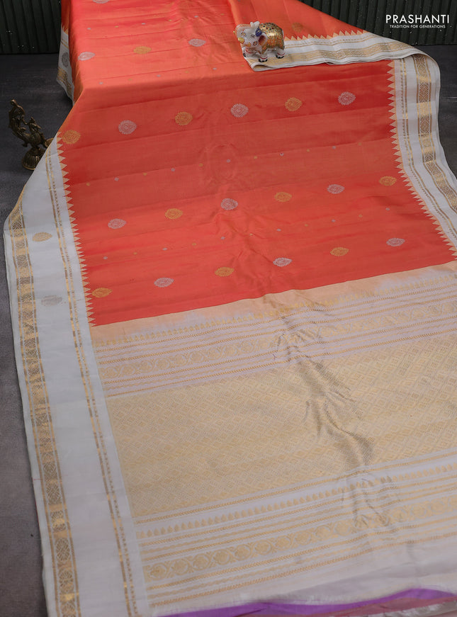 Pure gadwal silk saree dual shade of pinkish peach orange and off white with silver & gold zari woven buttas and temple design rettapet zari woven butta border