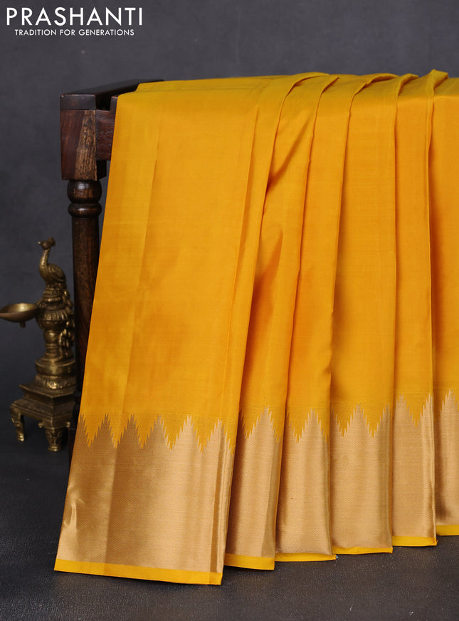 Pure kanchipuram silk saree yellow with plain body and rich temple zari woven border