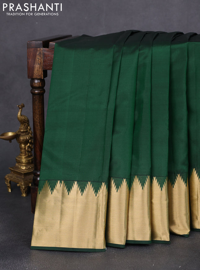 Pure kanchipuram silk saree bottle green with plain body and rich temple zari woven border