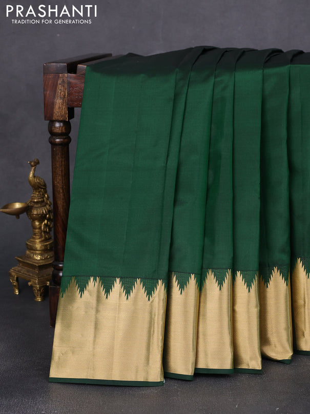 Pure kanchipuram silk saree bottle green with plain body and rich temple zari woven border
