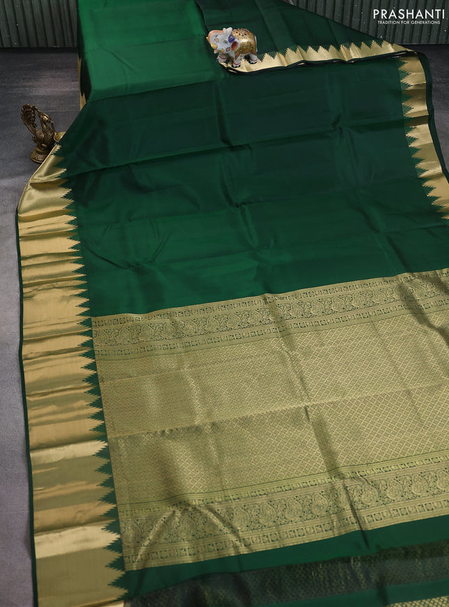 Pure kanchipuram silk saree bottle green with plain body and rich temple zari woven border
