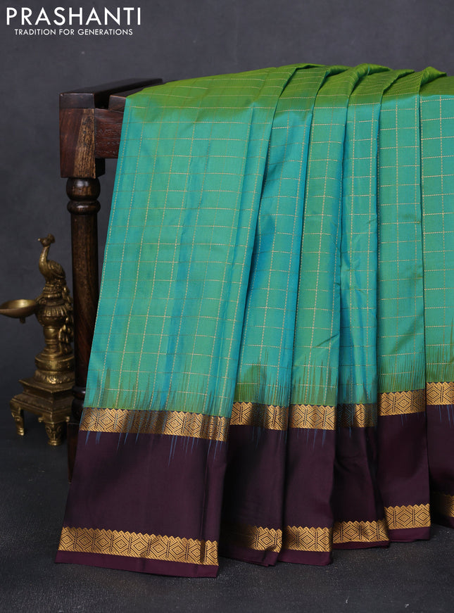 Pure kanchipuram silk saree dual shade of teal green and wine shade with allover checked pattern and rettapet zari wonen border
