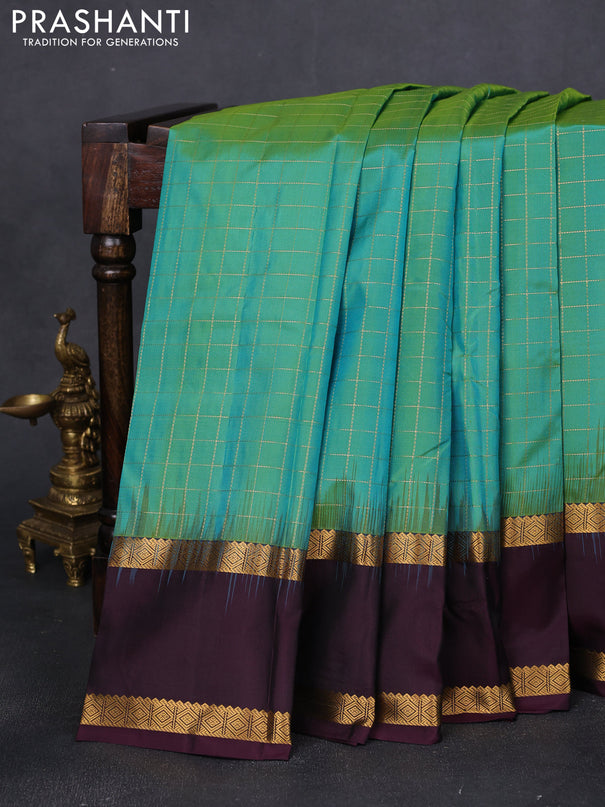 Pure kanchipuram silk saree dual shade of teal green and wine shade with allover checked pattern and rettapet zari wonen border
