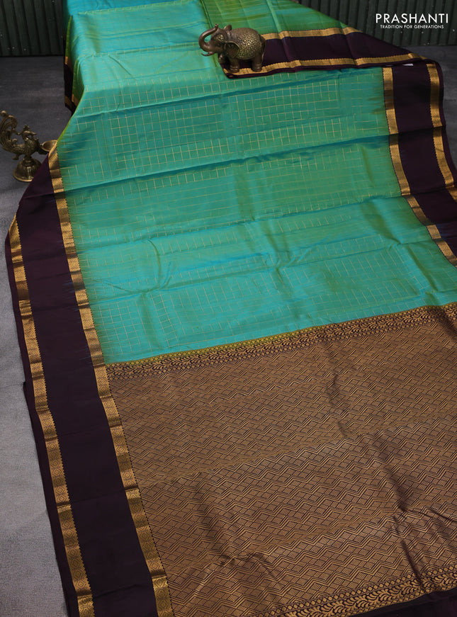 Pure kanchipuram silk saree dual shade of teal green and wine shade with allover checked pattern and rettapet zari wonen border