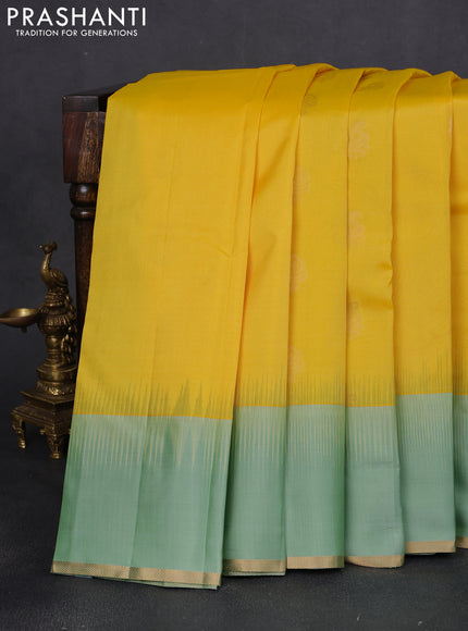 Pure kanchipuram silk saree yellow and pastel green with zari woven buttas and simple zari woven border