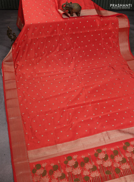 Semi raw silk saree orange with allover zari woven buttas and zari woven border