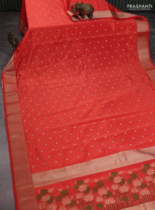 Semi raw silk saree orange with allover zari woven buttas and zari woven border