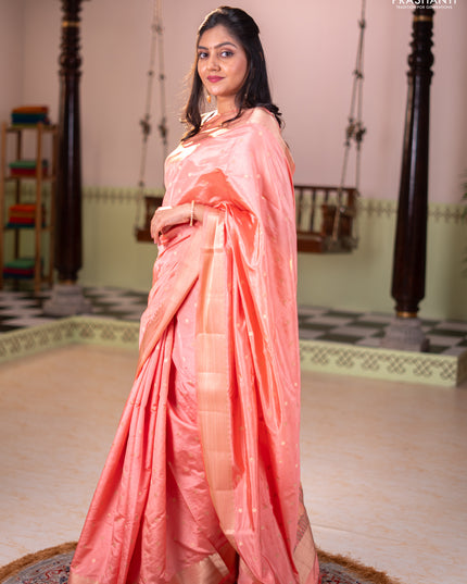 Semi raw silk saree orange with allover zari woven buttas and zari woven border
