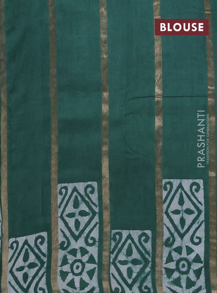 Semi chanderi saree green with allover zari strips & batik butta prints in borderless style