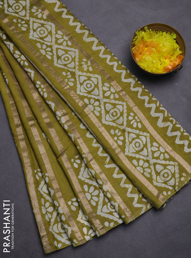 Semi chanderi saree mehendi green with allover zari strips & batik butta prints in borderless style