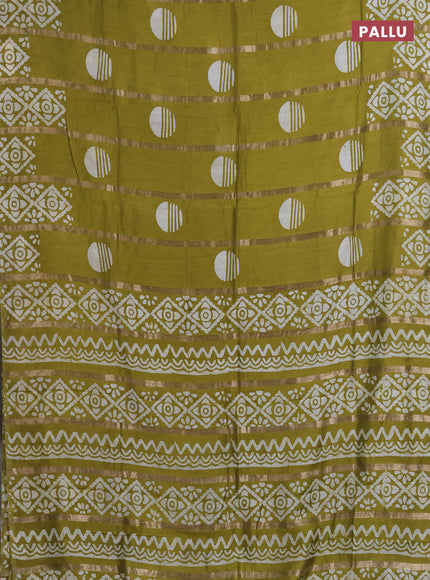 Semi chanderi saree mehendi green with allover zari strips & batik butta prints in borderless style