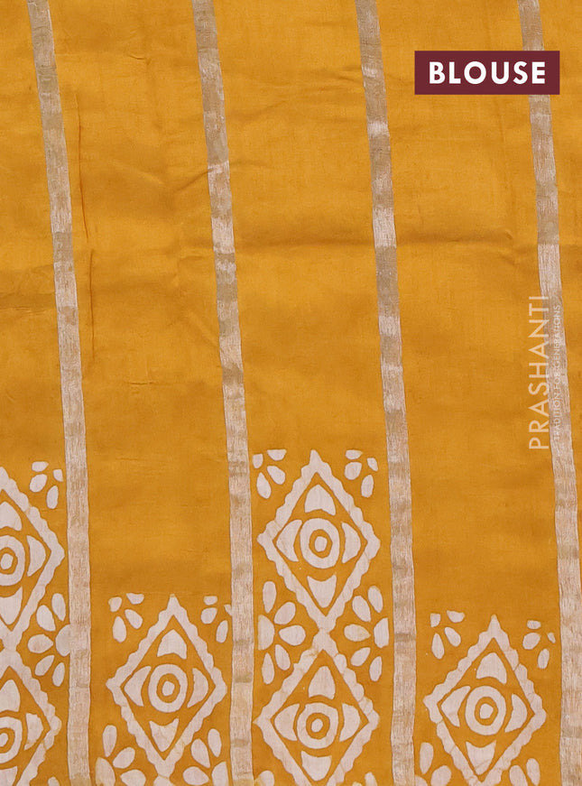 Semi chanderi saree mustard yellow with allover zari strips & batik butta prints in borderless style