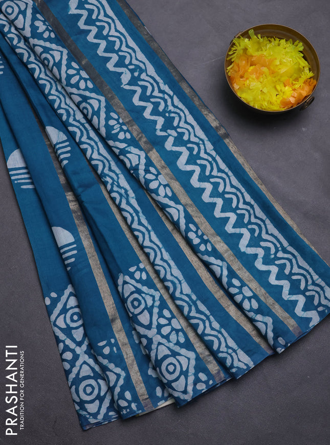 Semi chanderi saree peacock green with allover zari strips & batik butta prints in borderless style