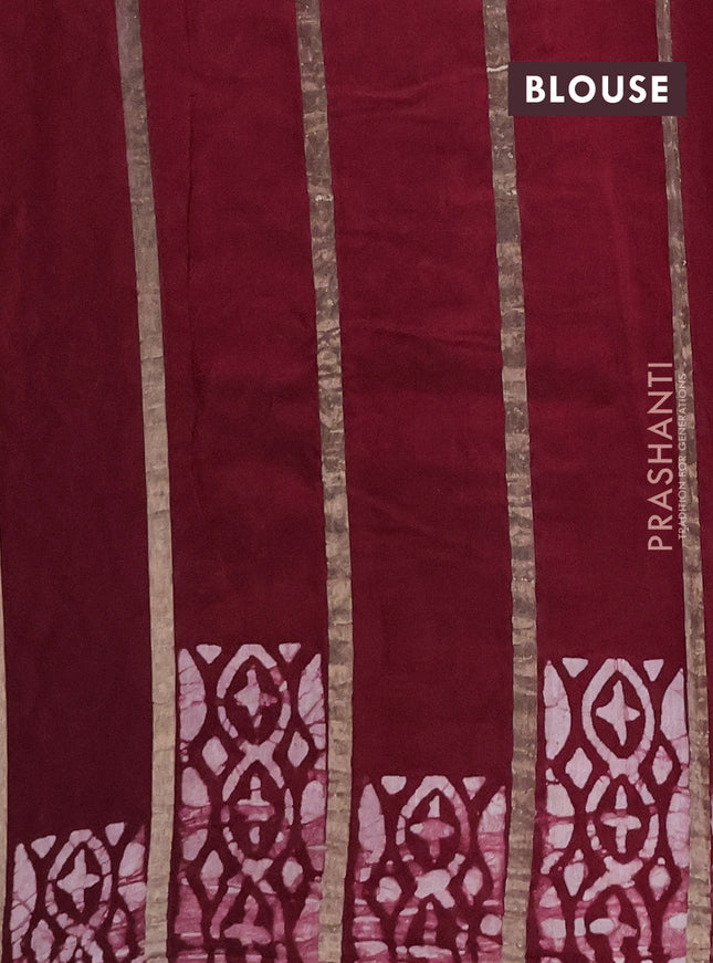 Semi chanderi saree maroon with allover zari strips & batik butta prints in borderless style