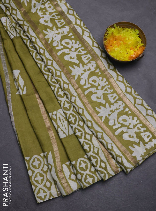 Semi chanderi saree mehendi green with allover zari strips & batik butta prints in borderless style