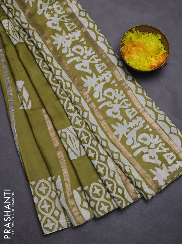 Semi chanderi saree mehendi green with allover zari strips & batik butta prints in borderless style