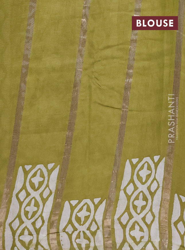 Semi chanderi saree mehendi green with allover zari strips & batik butta prints in borderless style