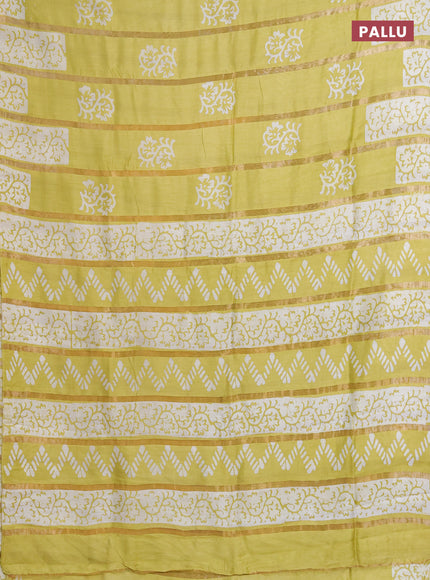Semi chanderi saree lime yellow with allover zari strips & batik butta prints in borderless style