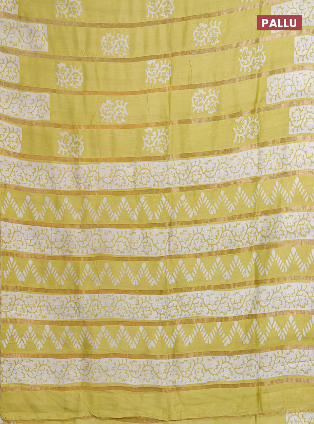 Semi chanderi saree lime yellow with allover zari strips & batik butta prints in borderless style